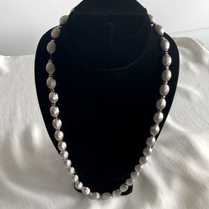 Beautiful Vintage brushed Silver tone Necklace. Beads are faceted on a chain.